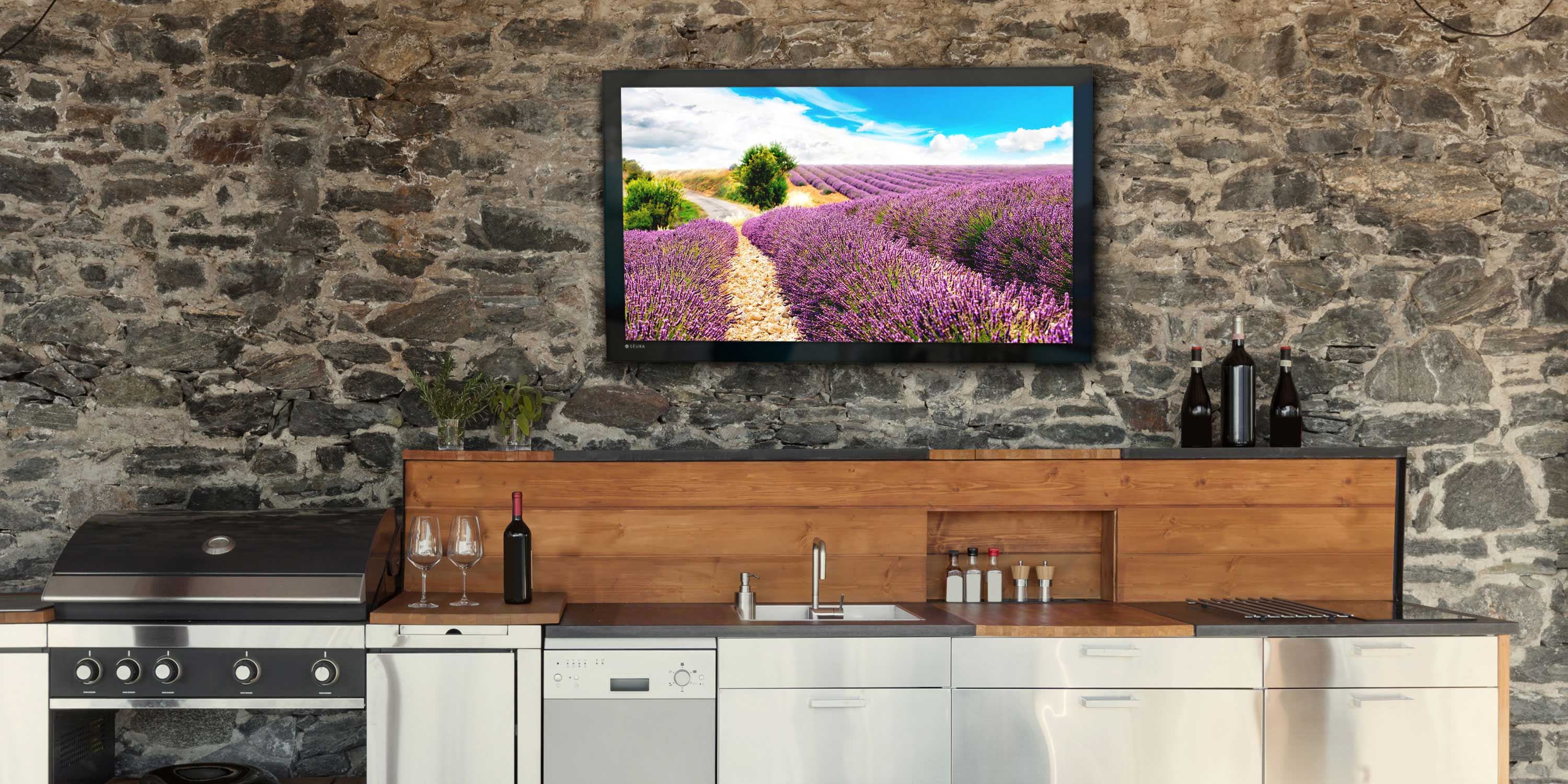 outdoor kitchen with Seura TV mounted on wall